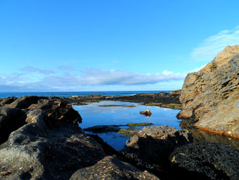 Rocks at west beach against cloudy sky