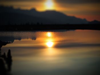 Scenic view of lake against romantic sky at sunset