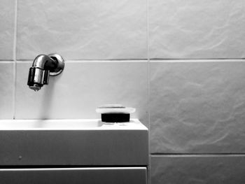 Close-up of electric lamp on wall at home