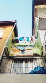 Clothes drying on built structure against clear blue sky