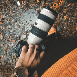 High angle view of man holding camera