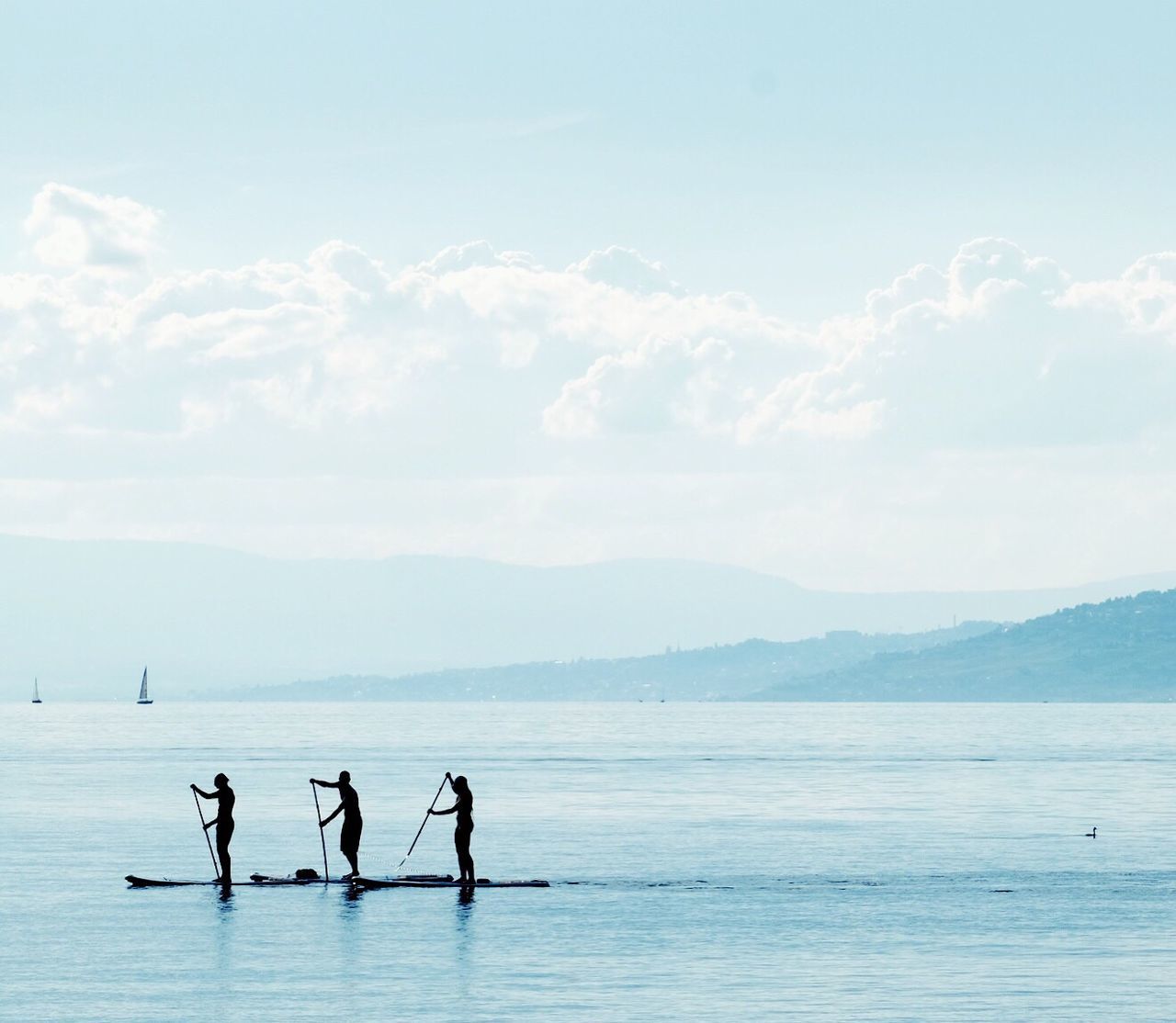 SILHOUETTE PEOPLE STANDING ON SEA AGAINST SKY