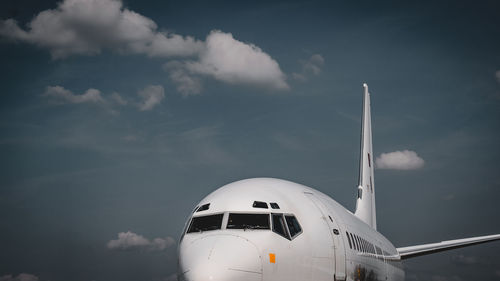 Low angle view of airplane flying against sky