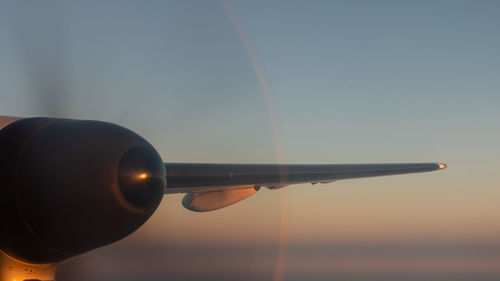 Close-up of propeller against sky at sunset