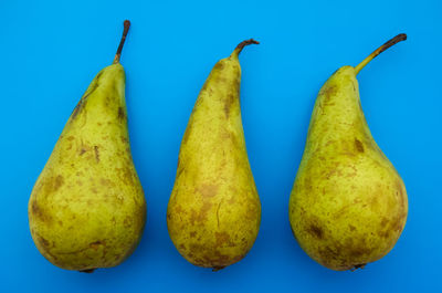 Close-up of fruits against blue background