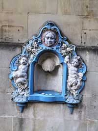 Statue against blue wall