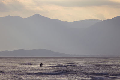 Scenic view of silhouette mountains against sky