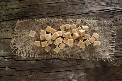 High angle view of sweet food on sack over wooden table