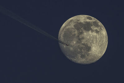 Low angle view of moon against sky at night