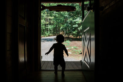 Boy standing by window