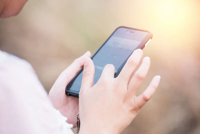 Midsection of man using mobile phone
