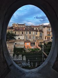 Buildings in city against cloudy sky
