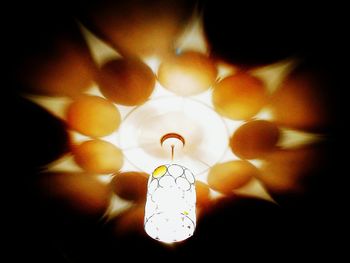 Low angle view of illuminated pendant light hanging from ceiling