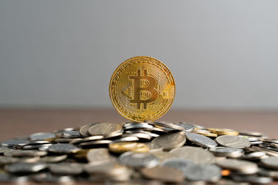 Close-up of coins on metal against white background