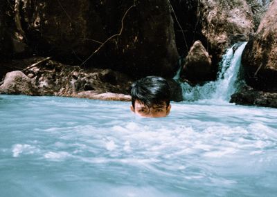 Portrait of boy swimming in pool