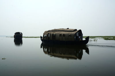 Boat on river against clear sky