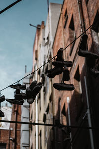 Low angle view of lighting equipment on building against sky