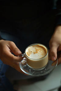 Midsection of coffee cup on table