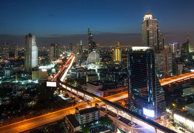 Aerial view of illuminated buildings in city at night