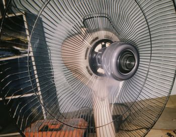 Low angle view of electric fan on ceiling