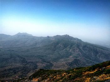 Scenic view of mountains against clear blue sky