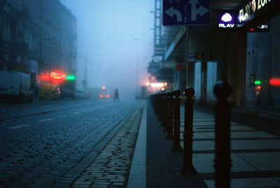 Bollards on city street during foggy weather