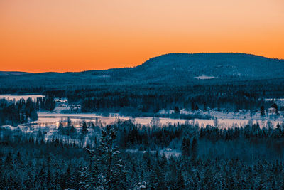 Scenic view of lake against orange sky