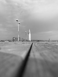 Surface level of lighthouse by sea against sky