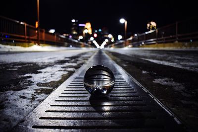 Close-up of snow on illuminated road at night