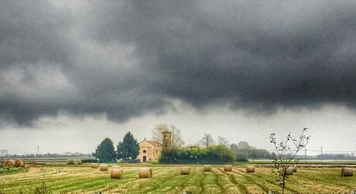 Panoramic view of field against storm clouds