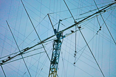 Low angle view of mast against clear blue sky