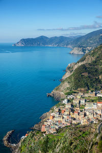 High angle view of townscape by sea against sky