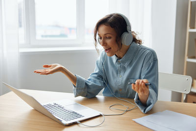 Side view of businesswoman working at office