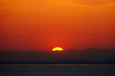 Scenic view of sea against romantic sky at sunset