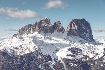 Scenic view of snowcapped mountains against sky near passo sella, dolomiti superski, italy