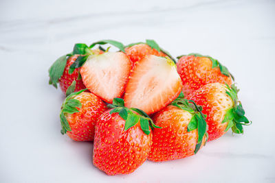 Close-up of strawberries on table against white background