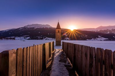 Scenic view of snowcapped mountains against sky during sunset