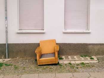 Abandoned armchair on sidewalk