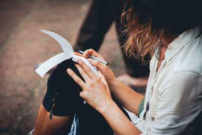 Close-up of hand holding paper