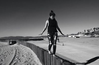 Full length of woman standing against clear sky