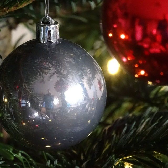 sphere, close-up, focus on foreground, lighting equipment, illuminated, transparent, hanging, glass - material, light bulb, christmas ornament, ball, christmas decoration, decoration, celebration, indoors, christmas tree, lantern, red, christmas, shiny