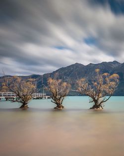 Scenic view of mountains against cloudy sky