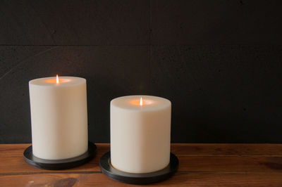 Close-up of illuminated tea light candles on table
