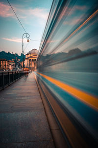 Blurred motion of train in city against sky