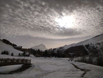 Scenic view of snow covered mountains against sky