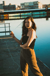 Full length of young woman standing on road