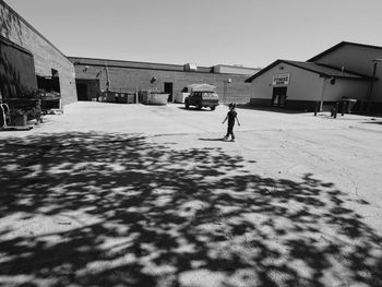 People walking on snow covered houses against clear sky