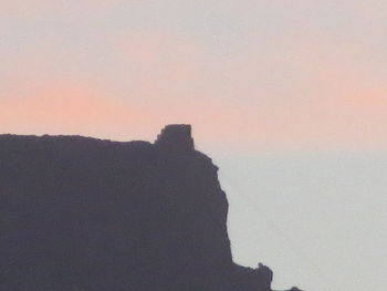 Silhouette mountain against sky during sunset