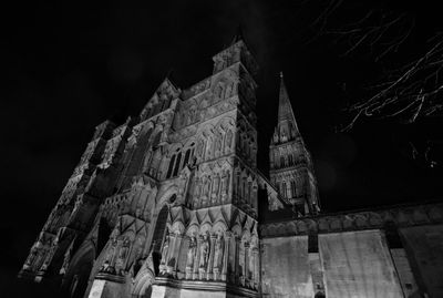 Low angle view of illuminated building against sky at night