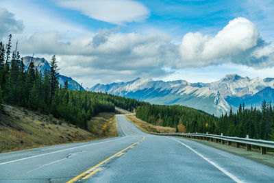 Road amidst mountains against sky